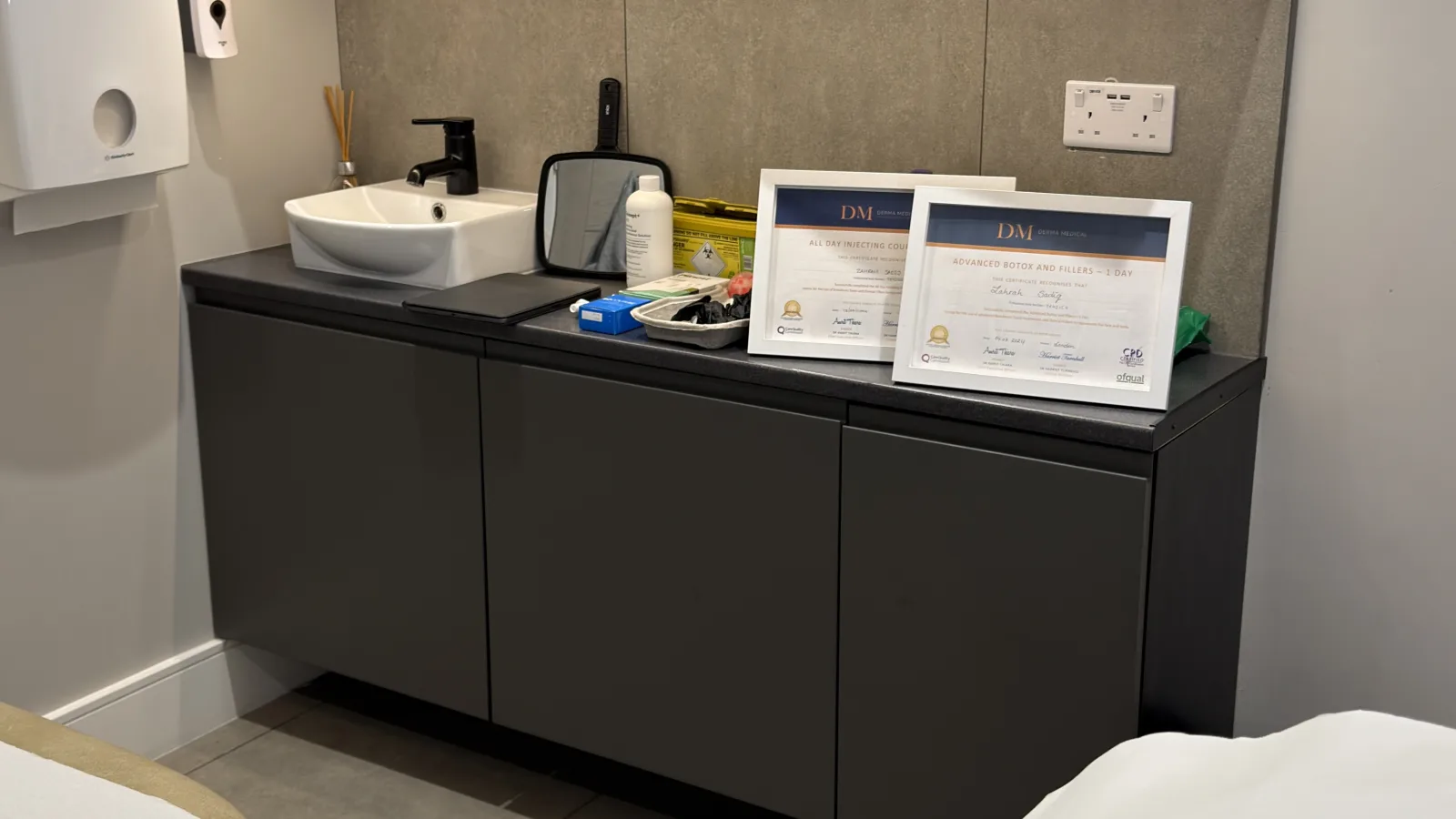 Dr. Zahrah's clinic training certificates on display